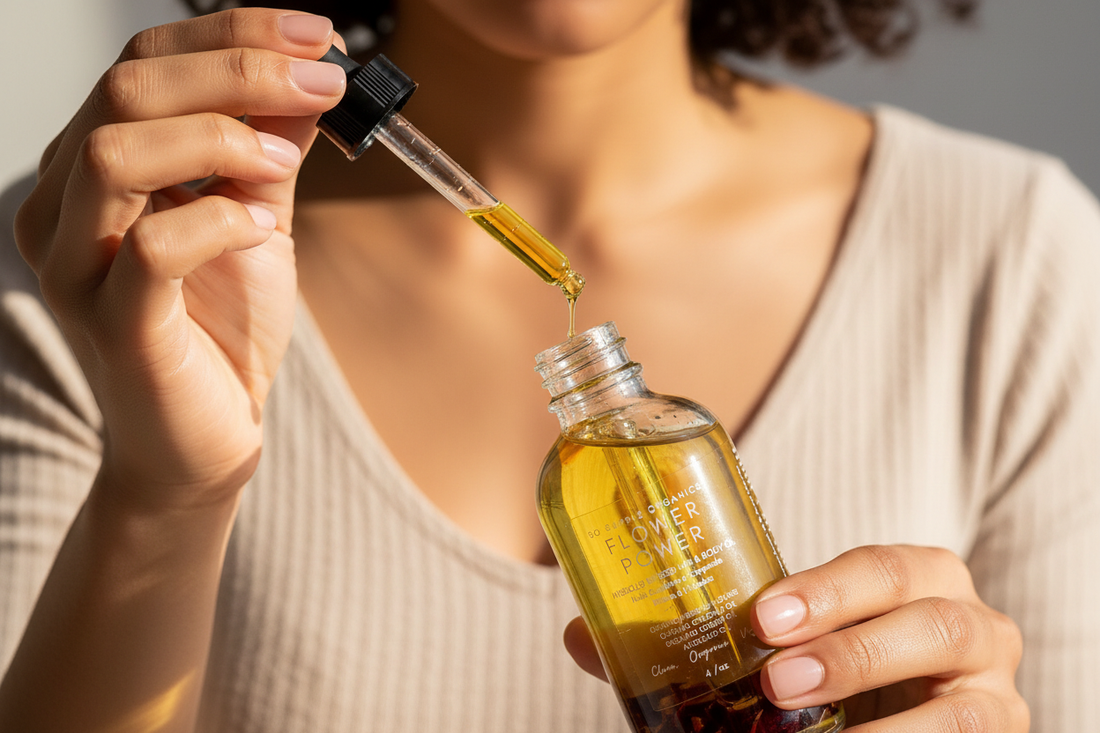Close-up of hands with Flower Power oil bottle and dropper
